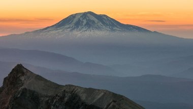 Mountain with fog at sunset Wallpaper