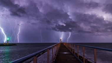 Lighting from pier and lighthouse Wallpaper