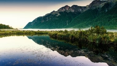 Lake reflecting mountains Wallpaper