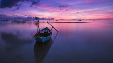 A boat at sunset Wallpaper