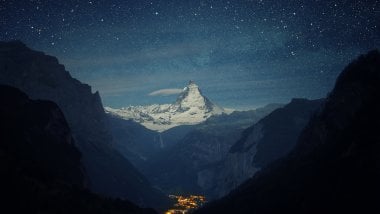 Snowy mountains with night stars Wallpaper