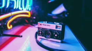 Vintage camera Rollei 35s with neon lights Wallpaper