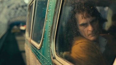 Joaquin Phoenix in train in Joker Wallpaper