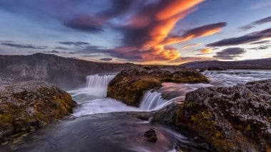 Waterfall in river in Iceland at sunset Wallpaper