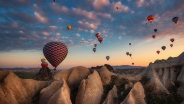 Hot Air Balloons in mountains at sunset Wallpaper