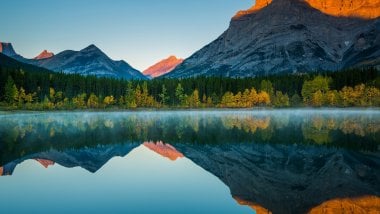 Mountains reflected in lake at sunset Wallpaper