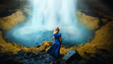Woman in a dress in front of waterfall Wallpaper