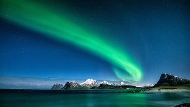 Northern lights in mountains and lake Wallpaper