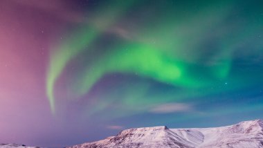 Green and pink norther lights in Island Wallpaper