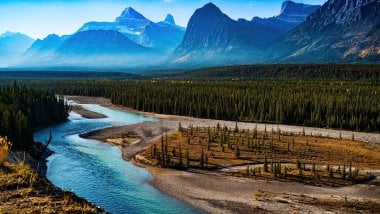 Landscape of mountains in forest with river Wallpaper