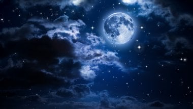 Moon in the clouds Wallpaper