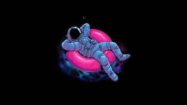 Astronaut laying on lifebuoy Wallpaper