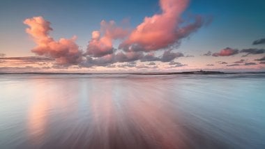 Clouds in the sea at sunset Wallpaper