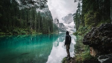 Man in front of lake in the woods Wallpaper