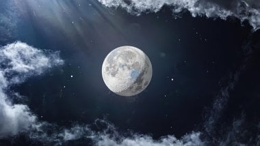 The moon next to clouds Wallpaper