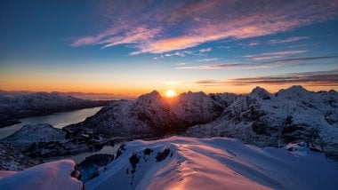 Sunset in snowy mountains Wallpaper