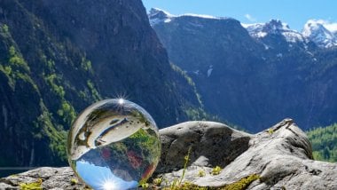 Glass ball reflecting the mountains Wallpaper