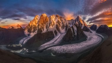 Sunset behind mountains with snow Wallpaper