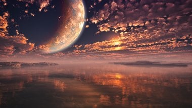 Moon over the clouds at sunset Wallpaper