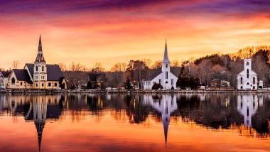 Chapel in front of river at sunset Wallpaper
