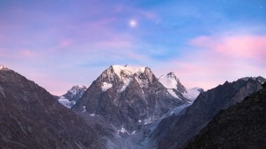 Mountain at sunset with a star in the sky Wallpaper