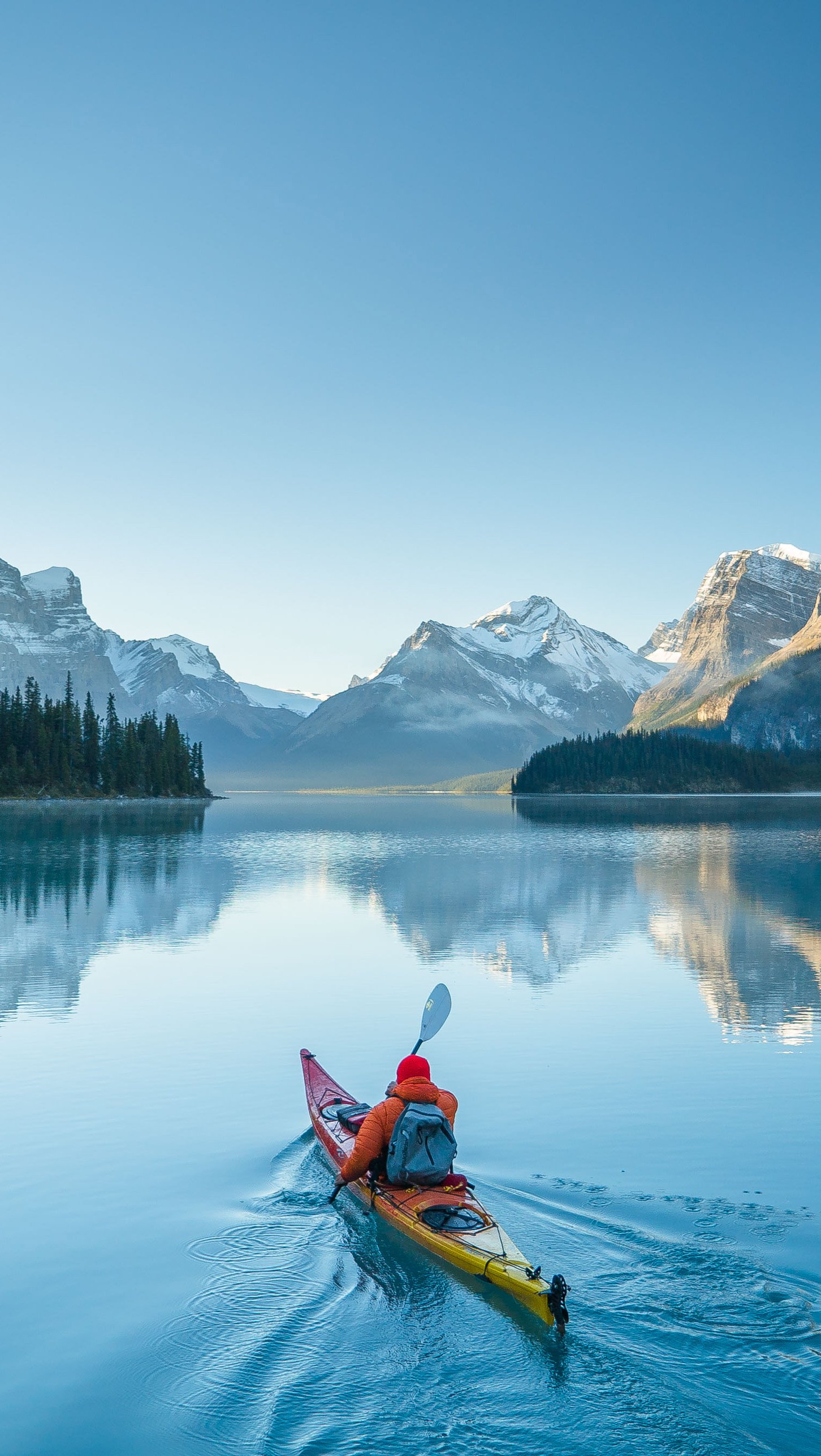 Wallpaper Canoes in lake beside mountains Vertical