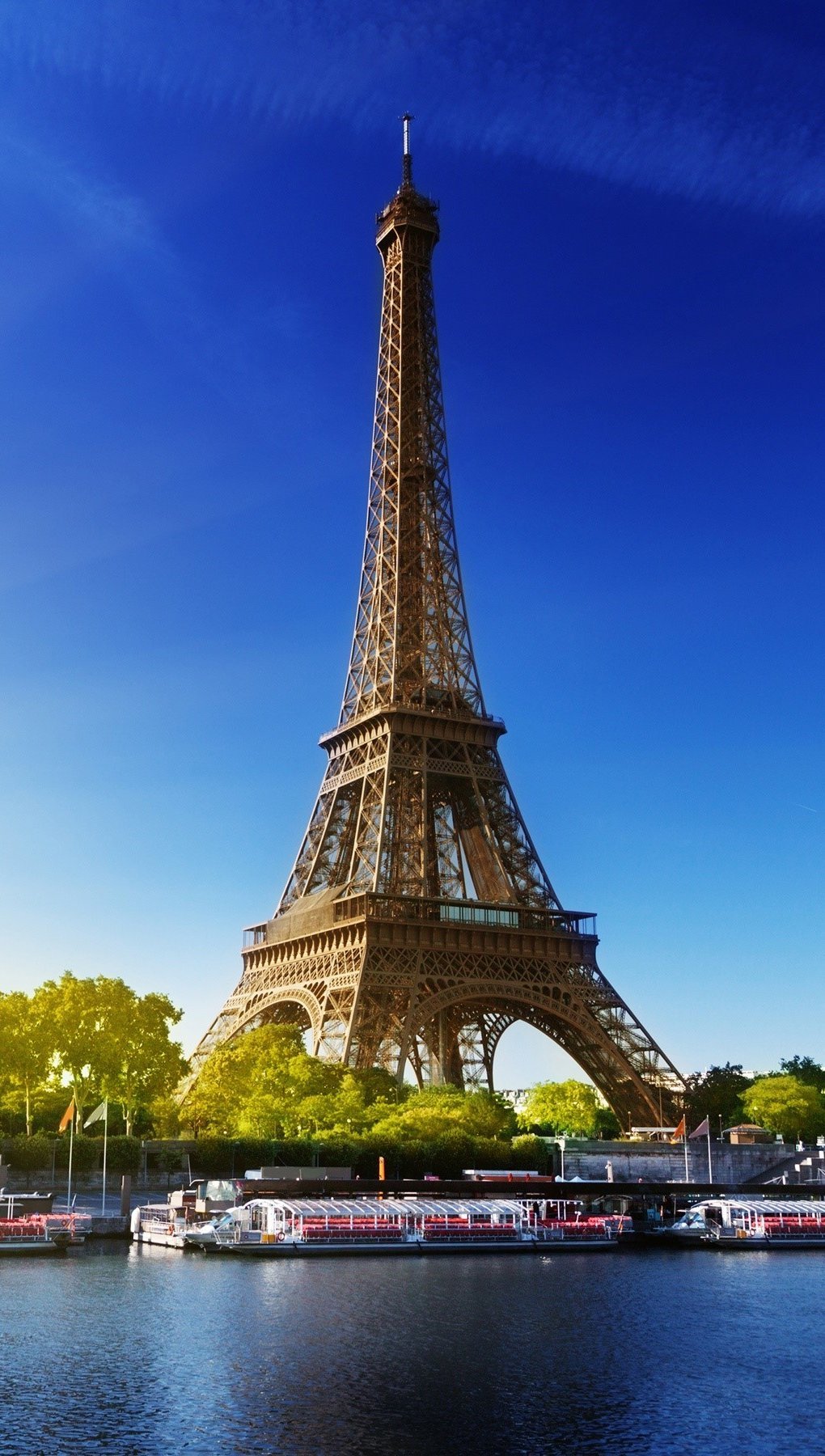 Fondos de pantalla La torre Eiffel y el sol Vertical