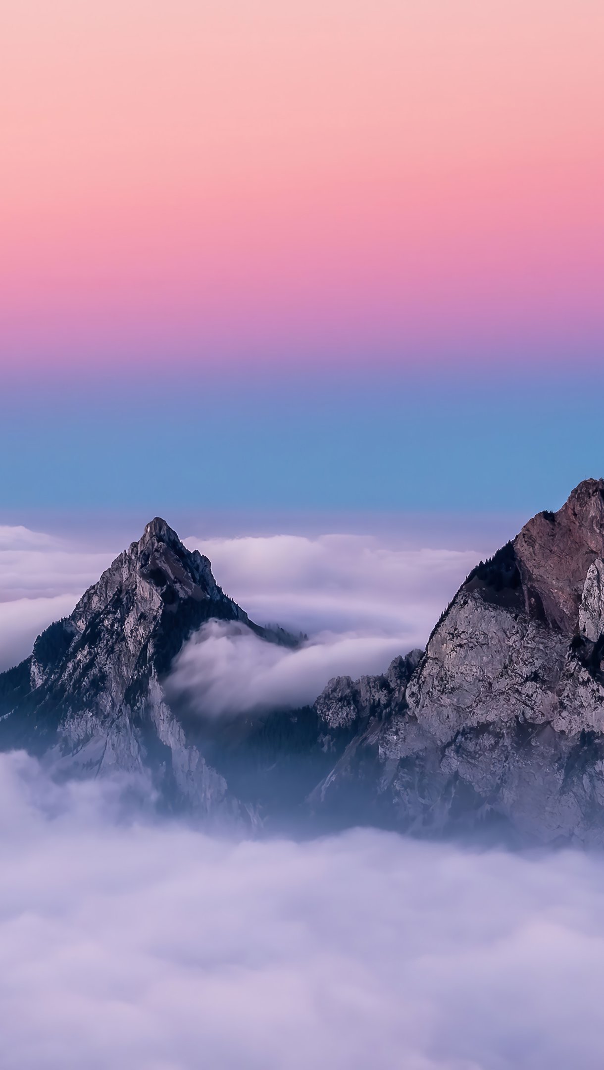 Wallpaper Mountains covered in clouds Vertical