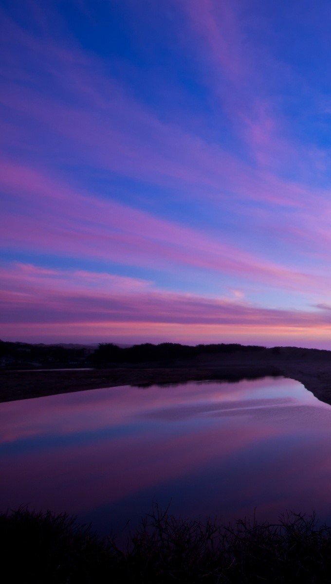 Wallpaper A river reflecting the sky Vertical